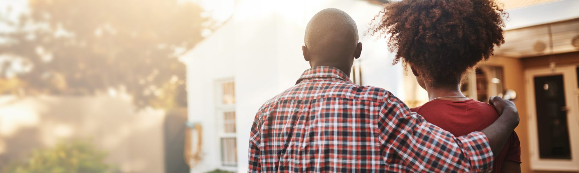 Back view, black couple and hug outdoor at house, real estate and new loan for luxury home. Man, woman and people in front of property investment, moving and dream neighborhood for building mortgage.